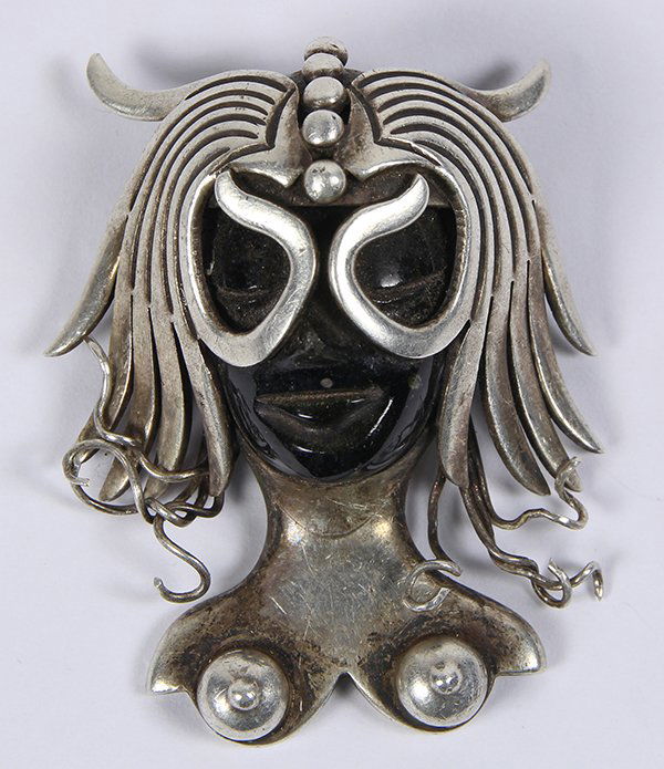 Los Balosteros Taxco obsidian and sterling silver: Los Balosteros Taxco obsidian and sterling silver pendant brooch depicting a stylized obsidian lady's face wearing a mask in sterling silver, Signed Los Balosteros, sterling silver 925 Hecho en Mexico