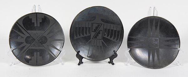 (lot of 3) Marie Santana San Ildefonso blackware plates: (lot of 3) Marie Santana San Ildefonso blackware plates, circa 1940, having abstract and zoomorphic designs painted in matte over a polished black slip, signed verso, "Marie", 8"dia.