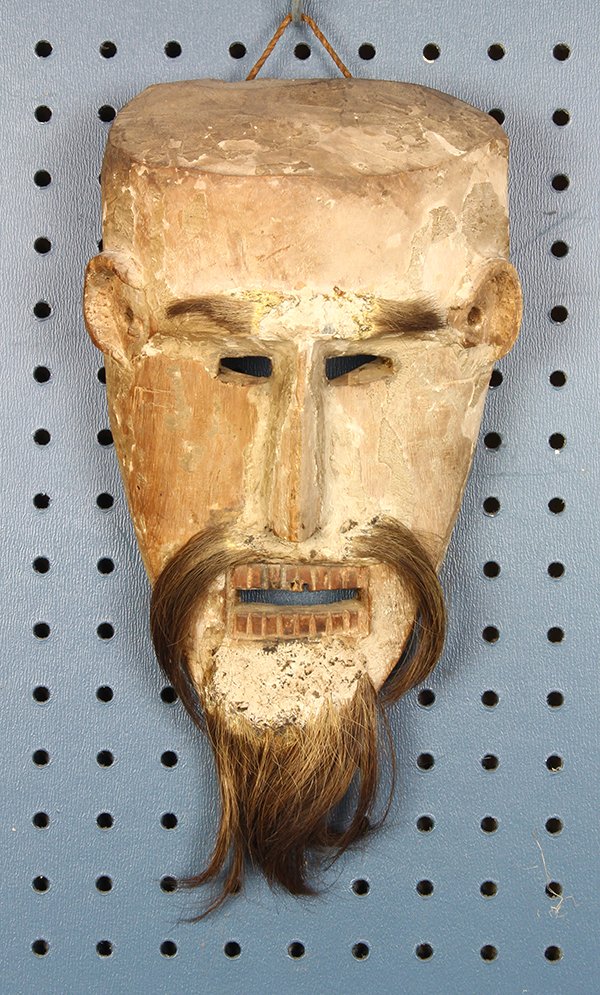 Himalayan mask, Bhutan or Nepal, probably 19th century,: Himalayan mask, Bhutan or Nepal, probably 19th century, the naturalistic face set with mustache and beard, and having an open mouth with two rows of teeth, 12.5"l. Provenance: The Collection of Allan 