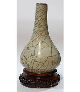 Chinese Ge-type Pear Form Vase: Chinese Ge-type pear shaped vase, the long neck splays toward the low slung pear form body, raised on a low foot, with networks of dark and gilt crackles on a beige ground, with wood stand, vase: 6.25