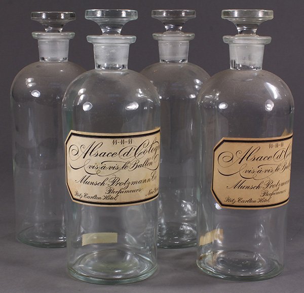 (Lot of 4) Apothecary jar group, having ground: (Lot of 4) Apothecary jar group, having ground stoppers, with paper labels reading "Alsace d'Cologne, Ritz Carlton Hotel, New York", 10"h