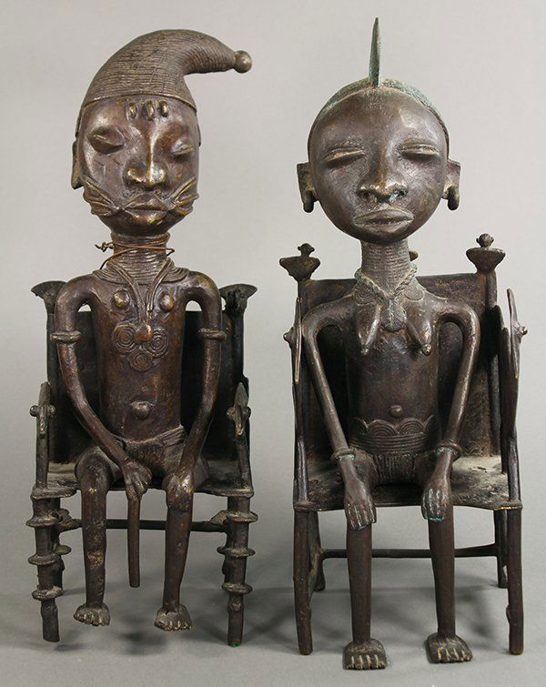 Pair of Yoruba metal figures, female and male, each: Pair of Yoruba metal figures, female and male, each naturalistically depicted seated in throne chairs with traditional garments, body jewelry and scarification, largest: 15"h