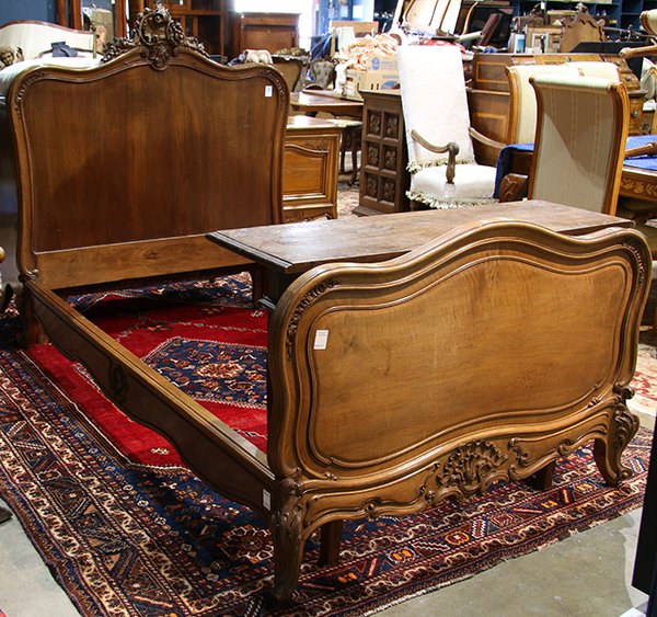 Louis XV style walnut bed frame, having a rocaille: Louis XV style walnut bed frame, having a rocaille carved crest and rising on cabriole legs, 55."h x 79"l x 50"d. Provenance: Property from the collection of Trotter’s Antiques, Pacific Grove CA