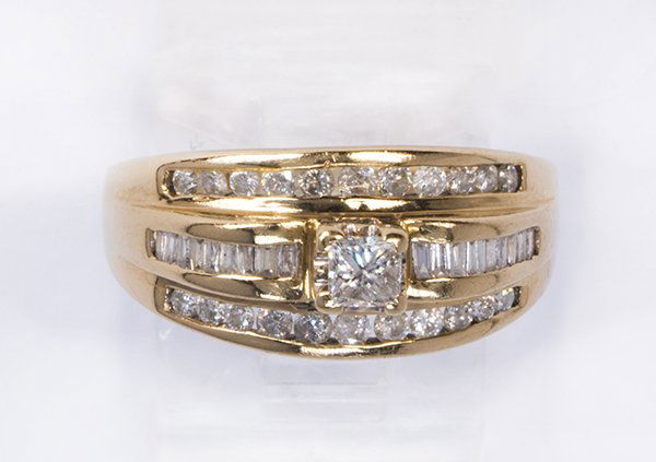 Diamond and 14k yellow gold ring: Diamond and 14k yellow gold ring featuring (1) princess-cut diamond, flanked by (18) baguette-cut diamonds, weighing a total of approximately 0.45 ct., further enhanced by (22) full-cut diamonds, weig