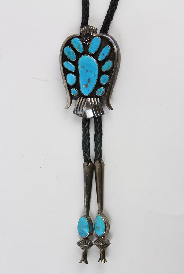 Johnny Pablo chrysocolla, silver bolo tie: Johnny Pablo chrysocolla, silver bolo tie resembling a bird in a shadow box, featuring (10) irregular chrysocolla cabochons, bezel set in a silver bolo mounting, measuring approximately 76 X 52 mm, ma