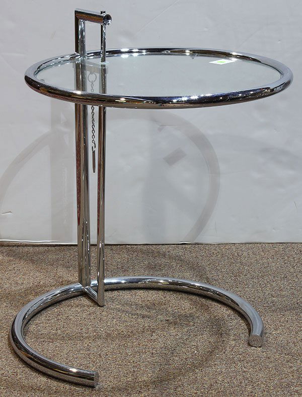 Eileen Gray chrome and glass adjustable side table: Eileen Gray chrome and glass adjustable side table, having a circular adjustable top, and rising on a tubular support terminating at the circular base, 26"h x 20"w