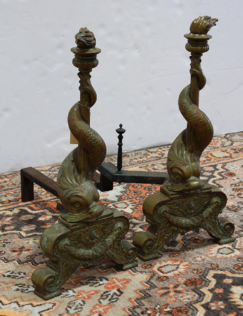 Pair of French bronze dolphin style chenets circa 1870: Pair of French bronze dolphin style chenets circa 1870, each dolphin depicted twisted around the columnar standard and rising on a footed base, 24"h