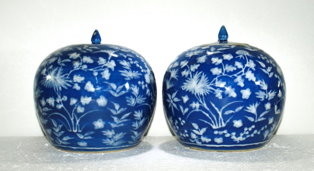 Pr. Antique Chinese porcelain jars: Pr. Antique Chinese blue ground w/ white relief flowers porcelain jars ---Height P1: 7 1/2 in. Width P1: 9 1/8 in Depth P1: 9 1/8 in ---Height P2: 7 5/8 in. Width P2: 9 1/8 in. Depth P2: 9 1/8 in. ---