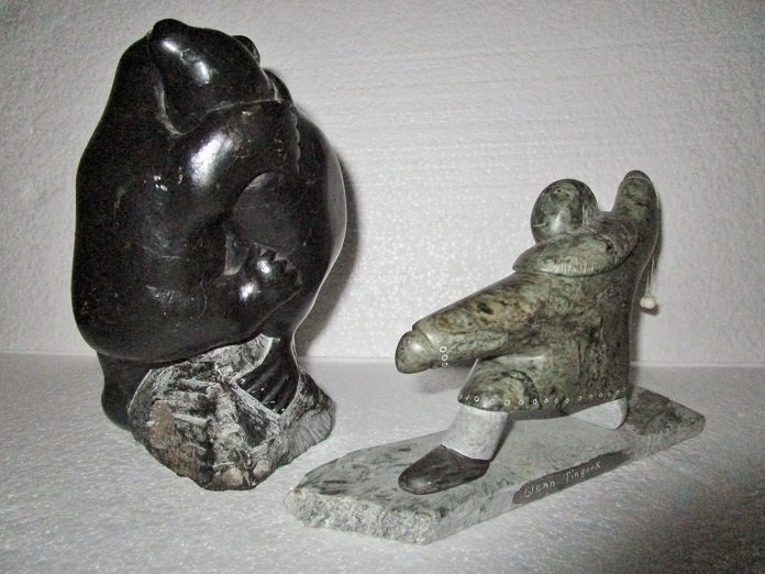 Group of 2 Inuit Eskimo soapstone carvings: Bear carving - 7" tall x 4" wide x 4" deep. Signed E9-931Man - 5" tall x 8" wide x 2" deep. Signed Glen Tingook