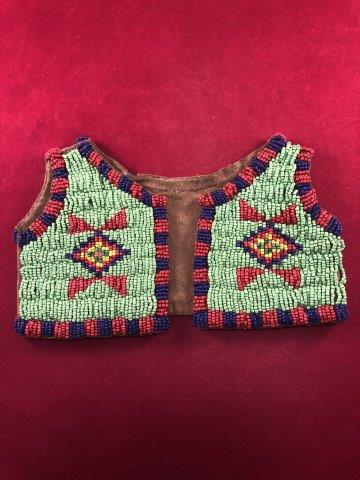 SIOUX BEADED INFANT VEST INDIAN ARTIFACT POTTERY: THIS BEAUTIFUL NATIVE AMERICAN INDIAN ARTIFACT IS 8&1/4 INCHES WIDE BY 4&7/8 TALL. IT IS FROM THE NORTHERN PLAINS. IT WILL MAKE A GREAT ADDITION TO YOUR COLLECTION! KEY WORDS: NATIVE AMERICAN INDIAN A