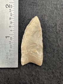 Meserve paleo point - small, sharp, well flaked with steep beveled edges and heavily ground base.