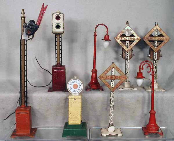 LIONEL ACCESSORIES: 80 semaphore; 78 train control, base restored; 2 #59 lamp posts, both are old repaints, 1 missing filigree; 87 crossing signal, die cast fatiguing; 2 #069 bell ringing warning signals, some surface ox