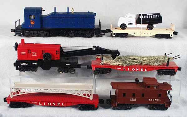 LIONEL TRAIN SET: O ga, 621 Jersey Central switcher, 6151 flat car w/reproduction Range Patrol truck, 6560 crane, 6826 Christmas tree flat car, 6825 flat w/girder bridge, 6557 smoking caboose, nick in roof corner & 1 b