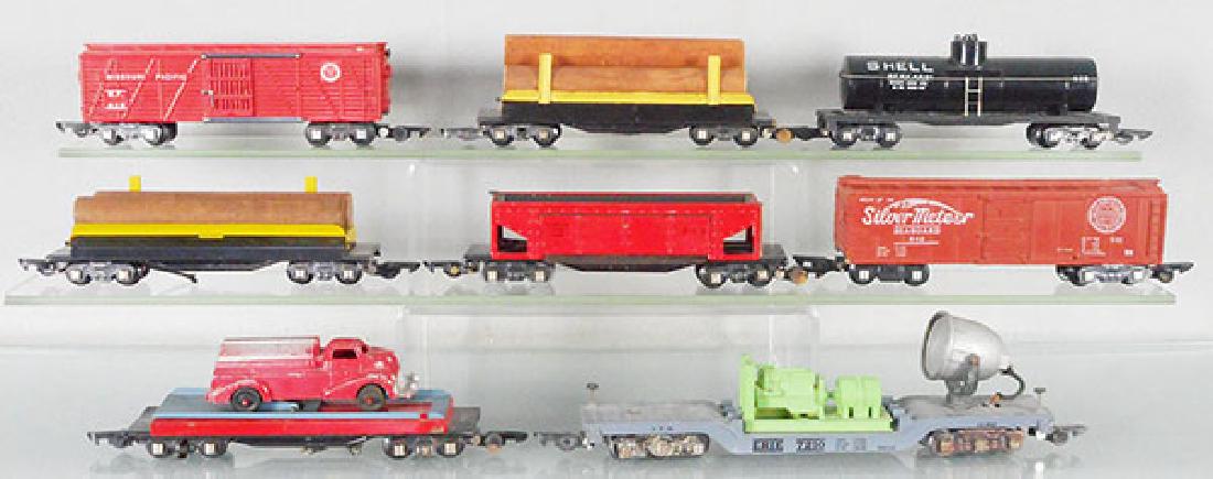 8 AMERICAN FLYER FREIGHT CARS: S ga, 629 stock, 2 #717 log car, 625 tank, 716 hopper, 642 box car, 715 flat w/auto, 946 searchlight, C5-7.