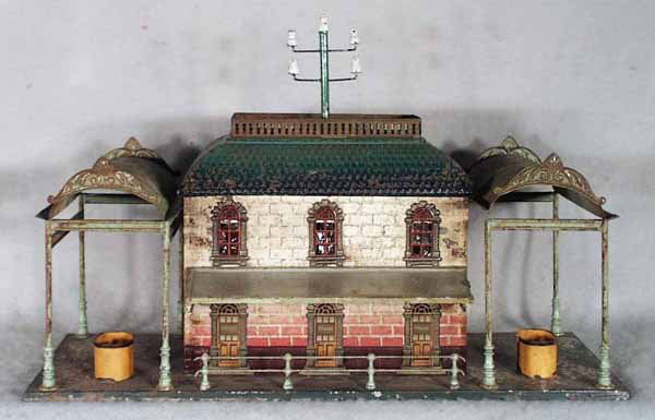 BING TRAIN STATION W/CANOPIES: handpainted tin, paint flaking, some surface oxidation, 16 1/2 in by 11 in, C3-4.