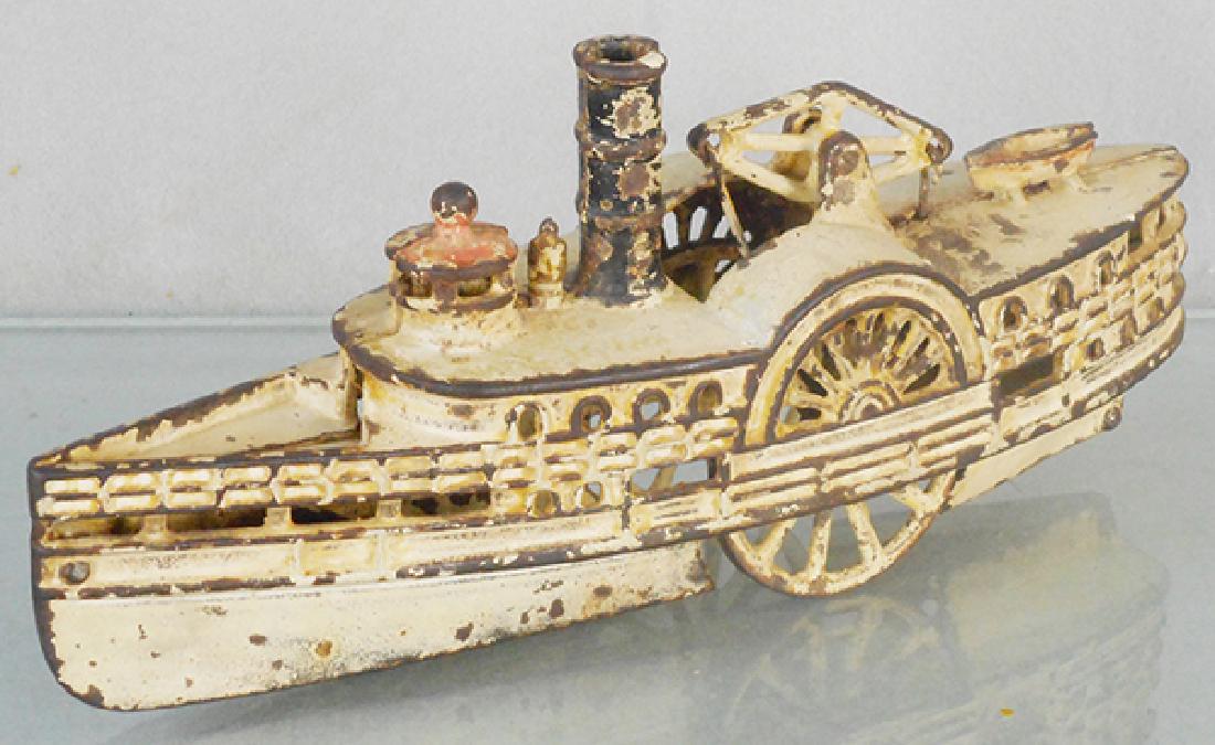 WILKINS PURITAN PADDLEBOAT: painted cast iron, 11 in long, w/eccentric front wheel & walking beam, some touch up on top deck, C3-4.