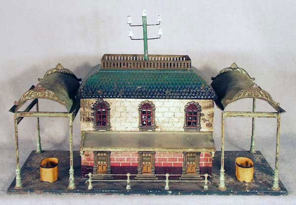 BING TRAIN STATION W/CANOPIES: handpainted tin, paint flaking, some surface oxidation, 10 1/2 in by 11 in, C3-4.