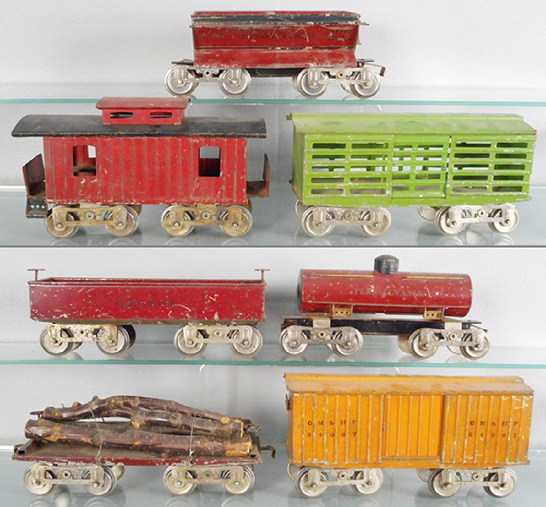 7 LIONEL FREIGHT CARS: std ga, 12 Lakeshore gondola, red, MFG, 15 PA tank, missing 1 step, 11 flat, 16 PA hopper, 13 stock, paint flaking on 1 end, 17 caboose, missing 2 steps, C4-5.