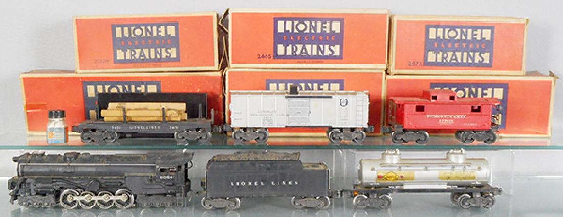 LIONEL 1421WS TRAIN SET: O ga, ca 1946, 2020 loco, w/Atomic motor, 2020W tender, 2465 tank, 1 step broken, 2 decals have edge chips, 3451 lumber dump w/bin, 3454 merchandise car, 2472 caboose, orig boxes & inserts some wear,