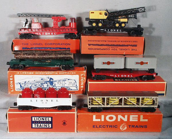 6 LIONEL FREIGHT CARS: O ga, 3512 fire ladder car; 6828 P&H crane; 6361 log car, rubberstamping weak; 6440 flat w/trailers; 6112-1 gondola w/canisters; 6465 pickle car, orig boxes worn & taped, some incom, C7-8.
