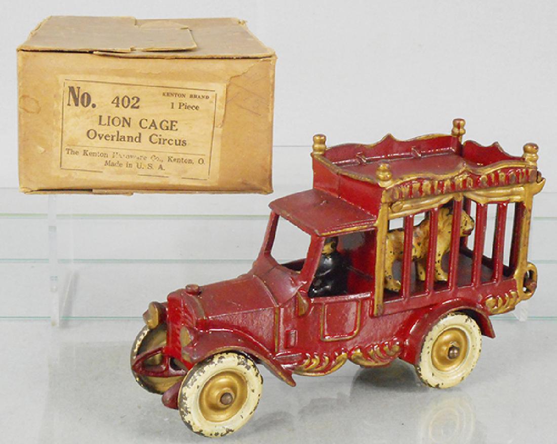 KENTON 42 OVERLAND CIRCUS LION CAGE: painted cast iron, 7 1/2 in long, w/driver & lion, paint worn on wheels, orig box worn, all flaps intact, C7.