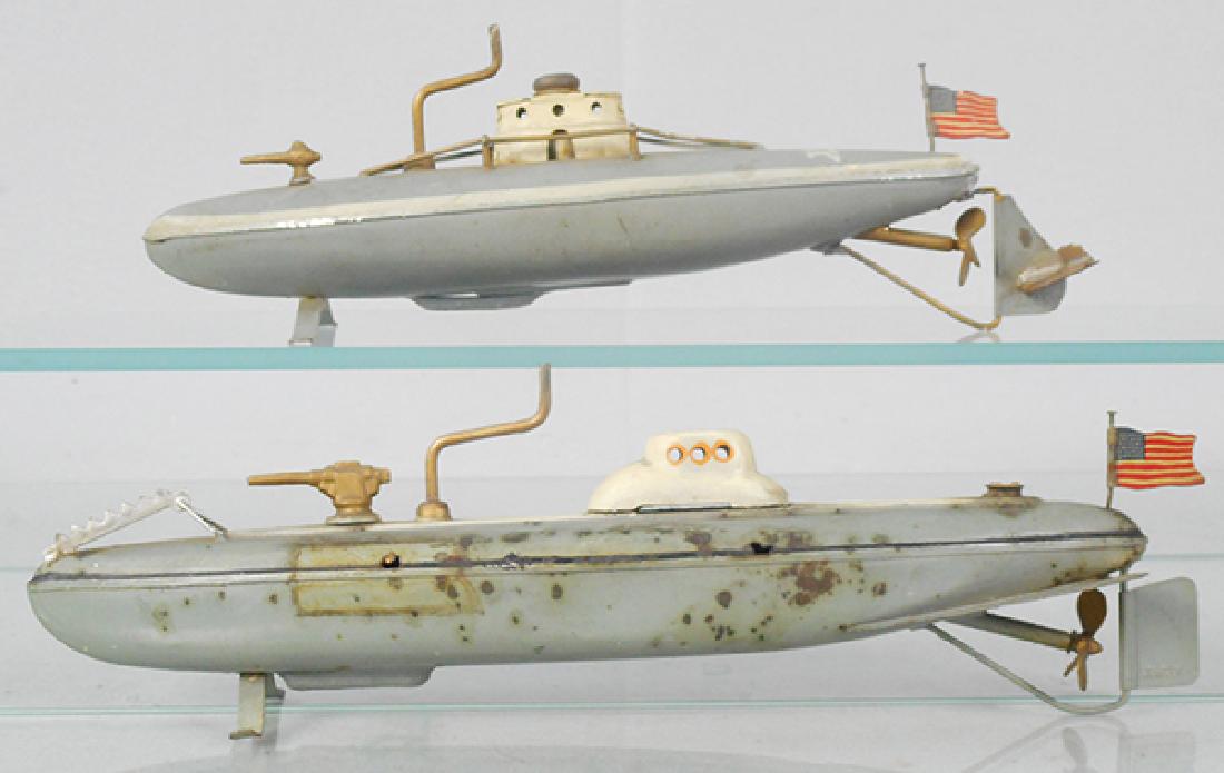 2 JAPANESE TOY SUBMARINES: litho tin, crane windup working, the top submarine has a resoldered rudder & is 9 1/2 in long, the other has oxidation spots & is 10 1/2 in long, C5-6.