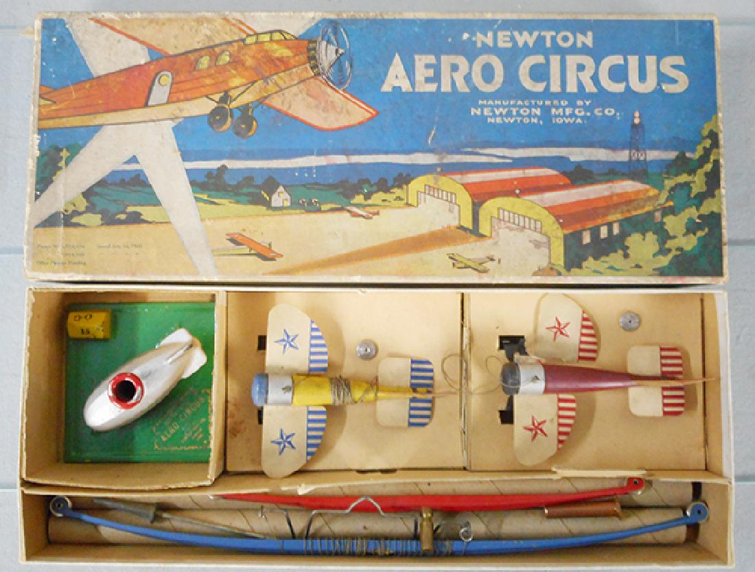 NEWTON AERO CIRCUS: wood, paper & cast iron, airplanes fly around base using cast iron blimp as counterweight, 1 plane has a broken paper wing, orig set box & insert, C7.