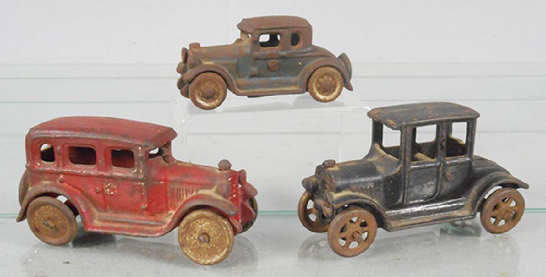 3 AC WILLIAMS AUTOS: painted cast iron, Sedan, red, 4 1/4 in long, Coupe, blue, 3 1/2 in long, Model T, black, 4 in long, some overall surface oxidation, C4.