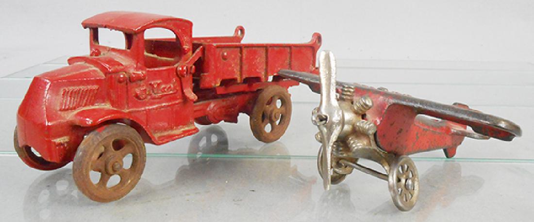 2 TOY VEHICLES: painted cast iron, Arcade Mack Dump Truck, 8 1/4 in long, repainted & missing tailgate, AC Williams UX166 Airplane, 6 in wingspan, C4-5.
