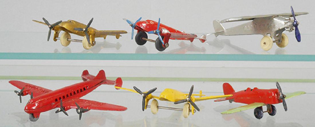 6 TOOTSIETOY AIRPLANES: 4660 Aero Dawn, 3 #125 Lockheed Electras, 1 red & silver, red paint chipped, 1 is yellow, 1 is gold, United DC-4 Super Mainliner, red, die cast pimpling, 106 Low Wing, red & green, C5-7.