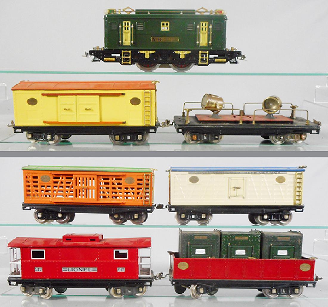 McCOY LIONEL TRAIN SET: std ga, McCoy 9E loco, 214 box car, 220 searchlight, 213 cattle car, 214R refrigerator, 212 gondola w/3 orig Lionel 205 containers, 217 caboose, cars are amateur restorations, loco C8, cars C5.