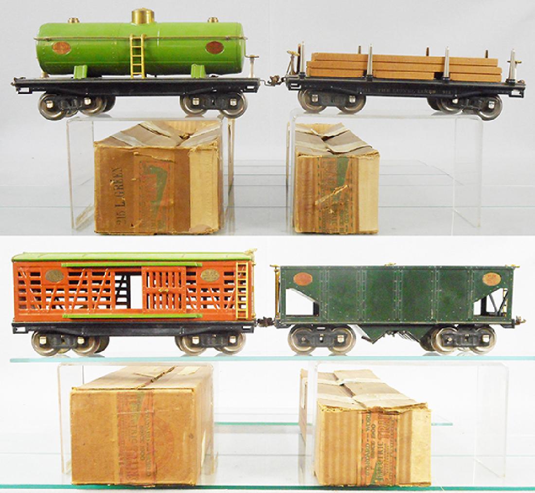 4 LIONEL FREIGHT CARS: std ga, 215 tank, 211 lumber, 213 stock car, paint chips on roof, missing 2 journal boxes, 216 hopper, missing 5 journal boxes, orig boxes rough, C6-8.