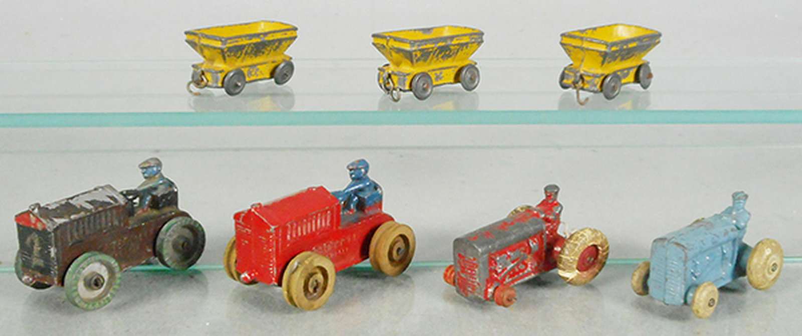 7 SLUSH DIE CAST VEHICLES: 2 #K7V58 Caterpillars, 2 BV128 tractors, 1 missing 2 wheels, w/3 Barclay trailers, C4-5.