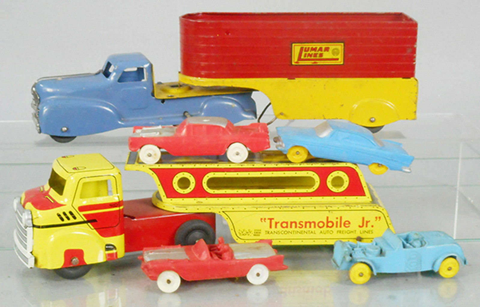 2 TOY TRUCKS: Lumar Tractor Trailer, 13 1/2 in long, windup working, Wyandotte Transmobile Jr, 12 1/2 in long, w/4 Auburn vinyl autos, C5-6.