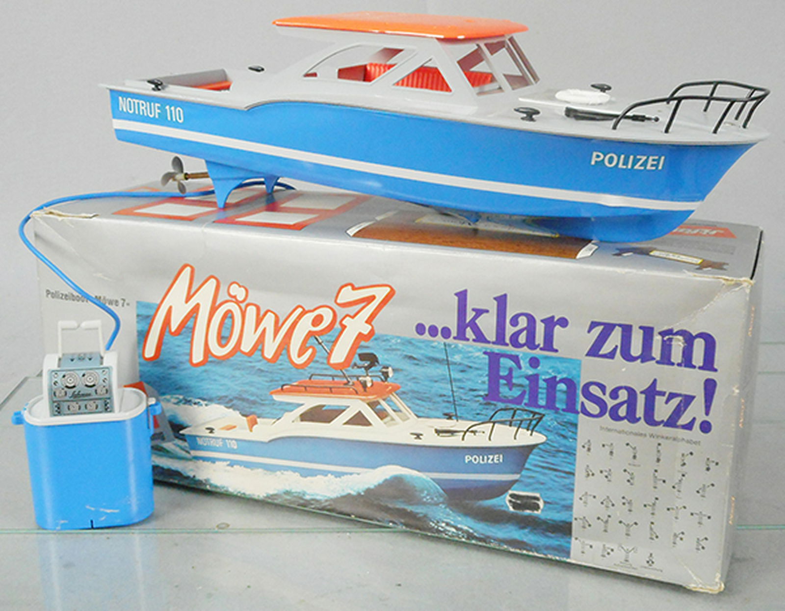 SCHUCO 703 379 POLICE LAUNCH: plastic, 16 in long, dual motors, battery operated, working, trim in orig bag, w/instructions, orig box some wear, C8.