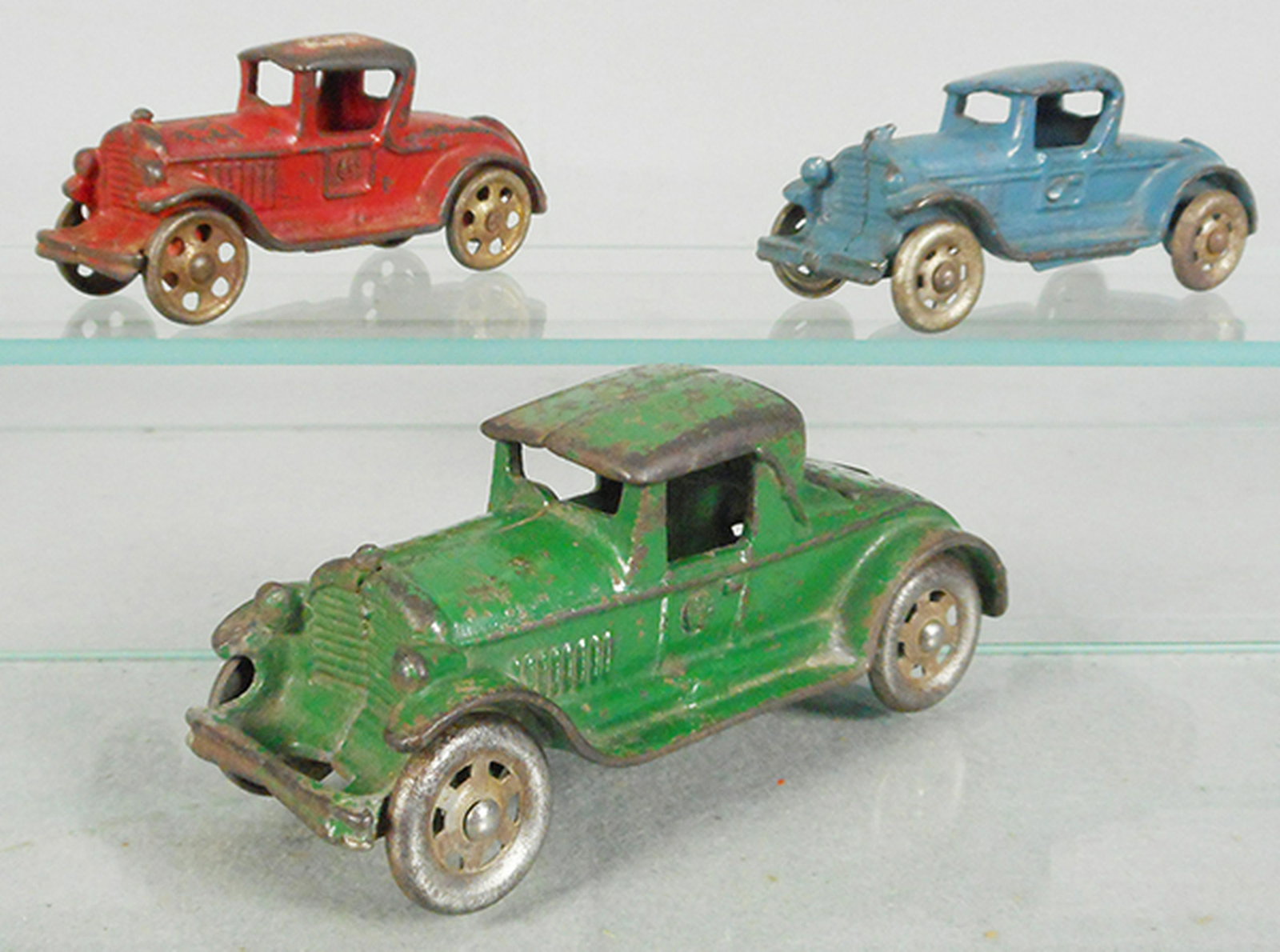 3 AC WILLIAMS AUTOS: painted cast iron, Coupe, red, 5 in long, Coupe, blue, 5 in long, Coupe w/rumble seat, green, 6 in long, C5.