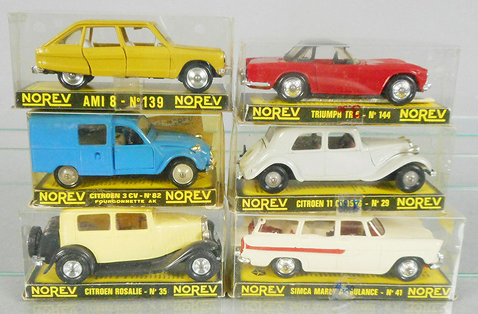 6 NOREV PLASTIC CARS: 139 Citroen Ami 8, 82 Citroen 3CV, 35 Citroen Rosalie, 144 Triumph TR5, 29 Citroen 11CV, 41 Simca Marly Ambulance, w/flags & stretcher, orig boxes minor wear, C8-9.