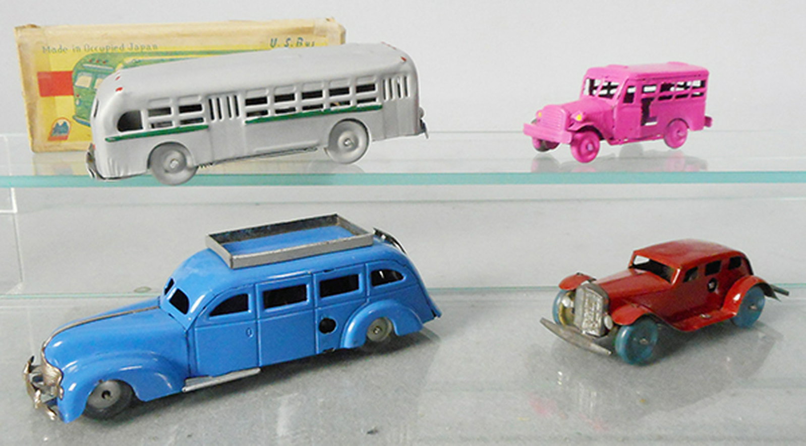 4 TIN VEHICLES: Paloma Shokai Bus, silver, windup working, 6 1/4 in long, orig box worn, Bus, pink, 4 1/4 in long, Auto Bus, blue, 6 1/4 in long, windup working, Auto, red, 4 1/4 in long, windup working, made in GB, 