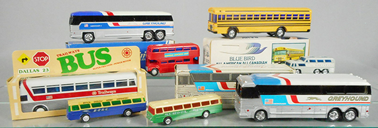 8 HONG KONG PLASTIC BUSES: Jimson 340 Greyhound Bank, 9 3/4 in long, 330 Bluebird School Bus Bank, 10 in long, Trailways Bus, 10 in long, Doubledecker Bus, 5 in long, Lucky Greyhound, 4 1/2 in long, 2 Blue Box Buses, 6 in long,