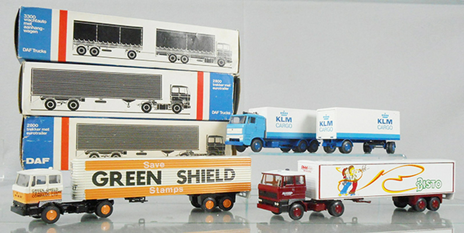 3 LION TOYS DAF TRUCKS: 59 Green Shield, 59 Bisto, 74 KLM Tractor Trailer, trailer has tiny paint flecks on it, orig boxes some wear, C8-9.