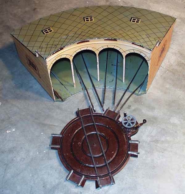 MARKLIN ROUNDHOUSE & TURNTABLE: 1 ga, the 2114/1 roundhouse is 28² long, handpainted tin, some flaking, missing 1 track piece, the 2131/1 turntable is handpainted tin, alligatored, missing inner cable to spin, C6.