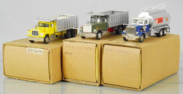 3 WHITE METAL TRUCKS: 2 Mack Dump Trucks, Peterbilt, Caltex Tank, approx 7 in long, orig boxes & inserts, C9.