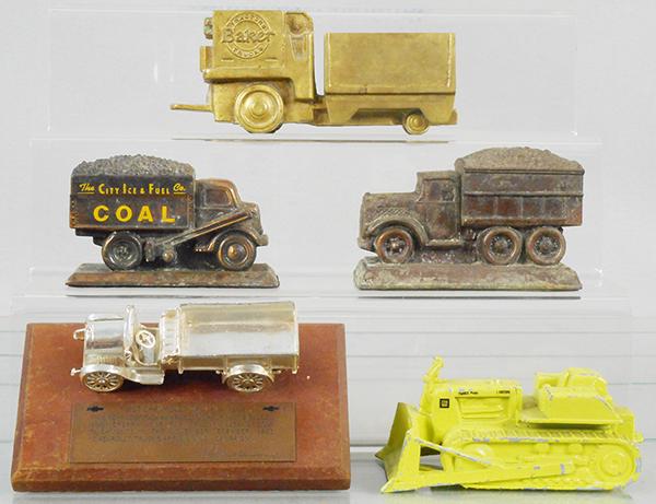 5 DIE CAST DESK PIECES: Baker Tractor Trucks, bronze, 7 1/4 in, Banthrico Coal Truck, 4 3/4 in, Coal Truck, 5 1/8 in, some corrosion, Chevrolet Truck, ca 1961, 7 in long, GM Terex, 5 1/2 in long, C5-8.