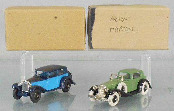 2 DG MODELS AUTOS: white metal, Aston Martin, 2-tone blue, all tires cracking, 7 Town Sedan, green, orig boxes minor wear, C9.