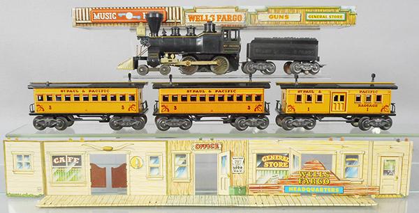 MARX WELLS FARGO TRAIN SET: O ga, Wm Crooks loco, handrails broken, Wells Fargo tender, 3 litho tin coaches, 4 tin buildings, stage coach & accessories in bags, orig set box worn, C5-7.