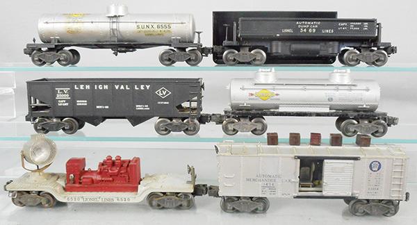 6 LIONEL FREIGHT CARS: O ga, 6555 Sunoco tank, decals yellowing, 3469 dump car w/bin, 6456 LV hopper, 6465 Sunoco tank, 6520 searchlight, 3454 merchandise car w/cubes, orig boxes worn, C5-6.