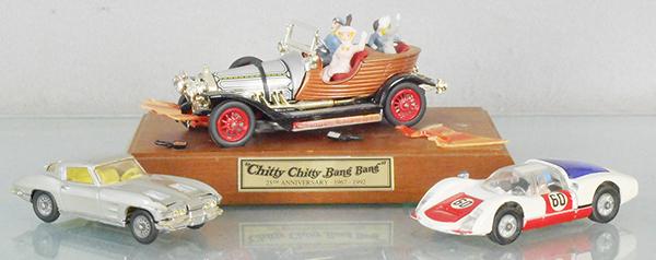3 CORGI VEHICLES: 310 Corvette Sting Ray, 330 Porsche Carrera 6, 25th Anniversary Chitty Chitty Bang Bang on display board, sunfaded, wing worn, C5-6.