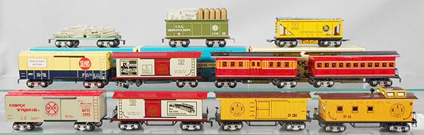11 MARX FREIGHT CARS: O ga, 7356 sandbag freight, 4166 ammo car, 73502 hopper, 9351 Sears, 7265 Empire box car, 19931 TTOS baggage, 19932 TTOS coach, 73511 Marx Club, 7262 Joyline box car, 7332-205 St. Paul box car, 733-44