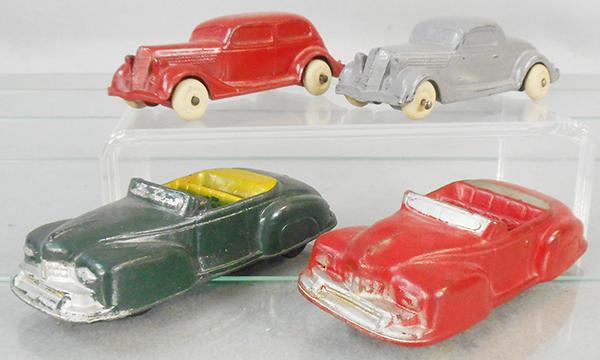 4 AUBURN RUBBER AUTOS: AA09 35 Ford, red, 4 in long, AA08 35 Ford, gray, 4 in long, AA13 Lincoln, green, 4 1/2 in long, AA12 Lincoln, red, 4 1/2 in long, C5-7.