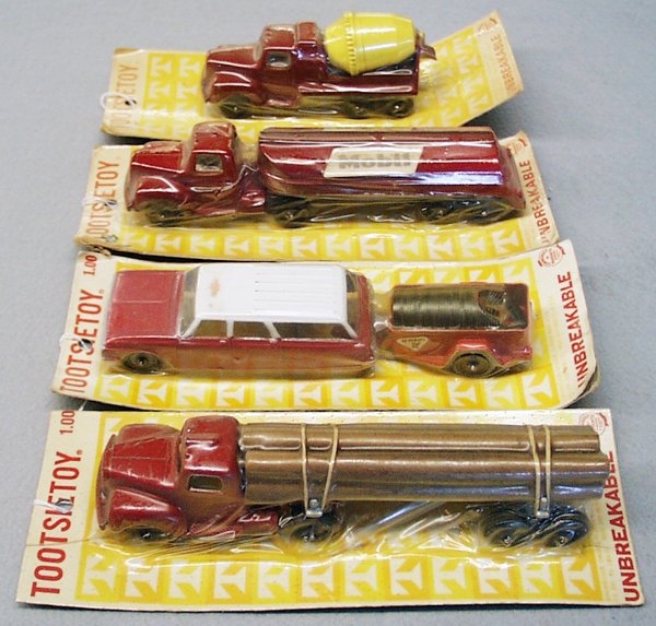 4 TOOTSIETOY CARDED VEHICLES: 2760 Mack Log Truck; 2825 Ford Wagon w/U-Haul Trailer, 2825 Mack Mobil Tanker, labels faded, 2945 Mack Cement Mixer, all sealed on orig cards, cards have minor wear, C10. Please read and understand al